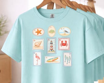 Coastal Stamps collage Women's Boxy Tee | Lighthouse, Crab, Seashells, Surfboard