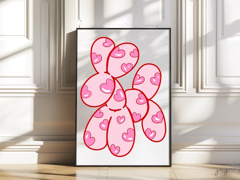 May include: A pink balloon animal shaped like a dog with a heart pattern. The balloon animal is on a white background.