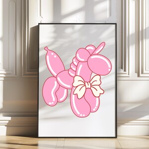 May include: A pink balloon animal shaped like a unicorn with a yellow bow. The unicorn is standing on a white background.