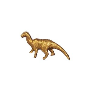 May include: A gold-coloured dinosaur figurine with a long tail and a textured surface.