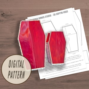 May include: Digital pattern for a 3D coffin vase. The pattern includes two sizes of coffins, with measurements in inches. The pattern is printed on white paper with black lines.