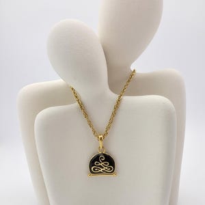 Nina Ricci Vintage Gold-Tone Necklace with Black Enamel & Ornate Monogram Pendant, Elegant Designer Jewelry with Adjustable Chain