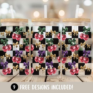 May include: Three glass tumblers with wooden lids and straws. The tumblers feature a black and white checkered pattern with cherry designs, gold, green, and purple bows. The text "9 FREE DESIGNS INCLUDED!" is at the bottom.