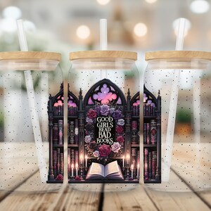 May include: Three clear glass tumblers with lids and straws. Each tumbler features a black and white illustration of a bookshelf with books and a gothic archway. The center tumbler has the text "Good Girls Read Bad Books" in the archway.