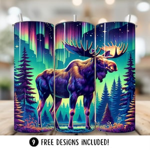 May include: A set of three stainless steel tumblers featuring a design of a moose standing in a forest with a colourful aurora borealis in the background. The tumblers are ideal for keeping drinks cold or hot.