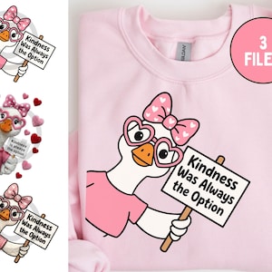 May include: Pink sweatshirt featuring a cartoon goose wearing heart-shaped glasses and a bow, holding a sign that reads "Kindness Was Always the Option." The design includes three files.