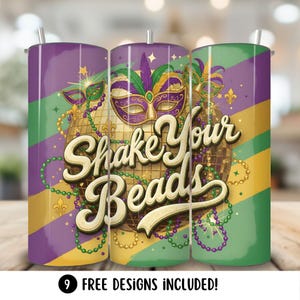 May include: Three stainless steel tumblers with a Mardi Gras theme. The design features a gold disco ball, masks, and the text "Shake Your Beads" in a decorative font. The tumblers have a purple, green, and gold color scheme.