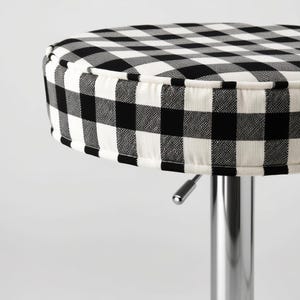 May include: A black and white checkered bar stool with a chrome base.