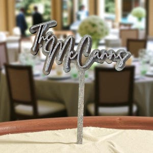 A decorative name tag on a table, with the name "McCann" written on it.