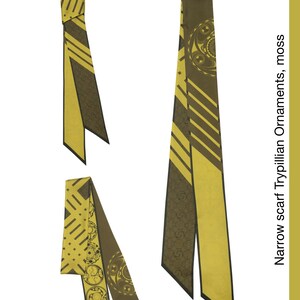 May include: A narrow yellow and brown scarf with a geometric pattern and a floral design. The scarf is tied in a knot at the top and the ends are hanging down. The text "Narrow scarf Trypillian ornaments, moss" is visible on the right side of the image.