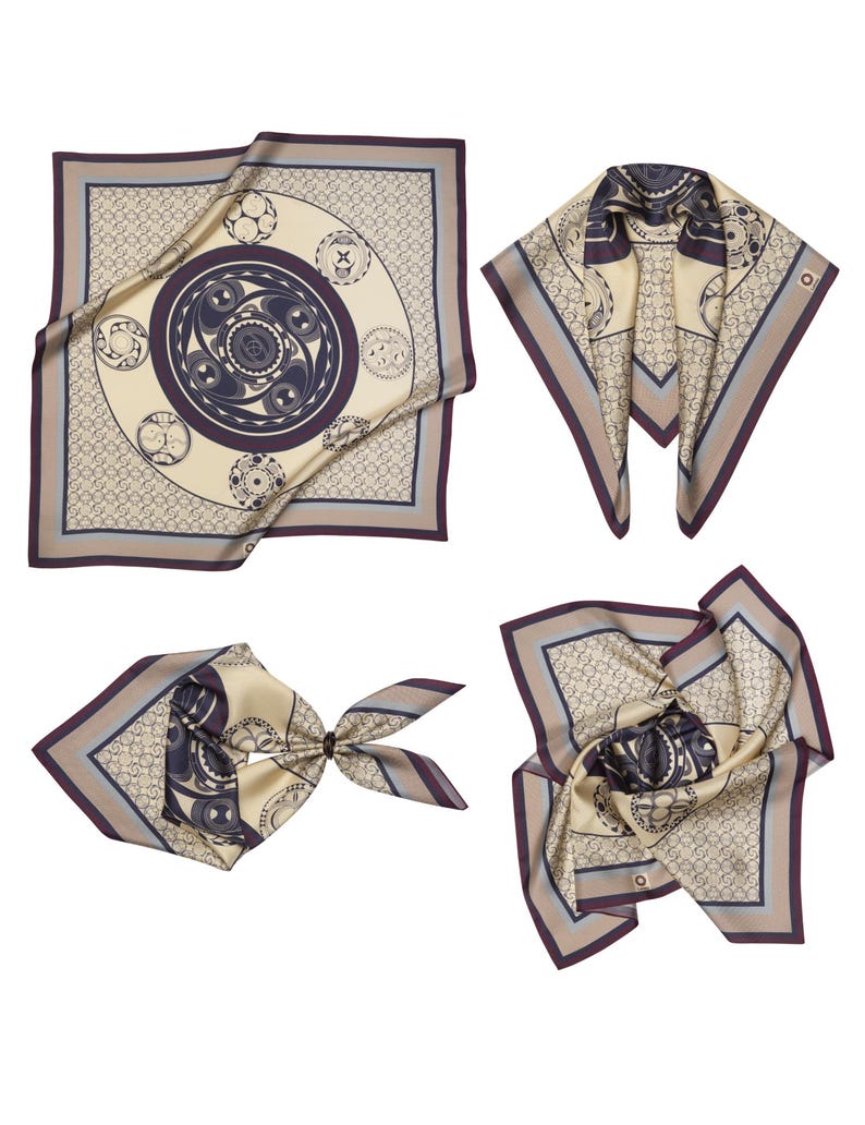 May include: Four silk scarves in different arrangements. Each scarf features a cream-colored background with a repeating pattern and a central design in navy and purple. The scarves have a border in shades of gray and purple.