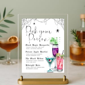 May include: A clear acrylic sign with a gold base displays a Halloween cocktail menu. The sign reads "Pick your Poison" with four cocktail names and ingredients listed below, each with a colourful illustration of the drink.