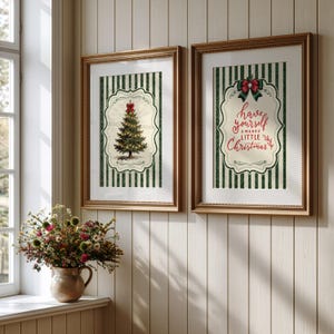 May include: Two framed wall art prints featuring a green and white vertical striped background. One print displays a decorated Christmas tree with a red bow, while the other features the red text Have yourself a merry little Christmas.
