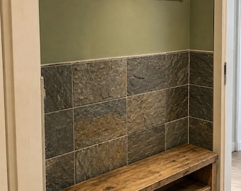 May include: A wooden entryway furniture set consisting of a wall-mounted coat rack with four black metal hooks and a matching two-tier shoe bench. The rack holds a glass jar with wooden spheres, a framed leaf print, and a small potted succulent.