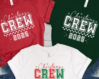 May include: Three t-shirts in red, white, and green, each with a unique design. The shirts feature the text "Christmas CREW 2025" in white, red, and green, with a festive font. The shirts are paired with blue denim jeans.