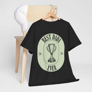 May include: Black t-shirt with a green circle graphic that says "Best Dada Ever" with a trophy inside the circle.