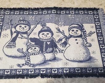 A pair of Snowman placemats
