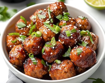 May include: A white bowl filled with small, round, brown meatballs topped with sesame seeds and green onions. The meatballs are arranged in a single layer and are surrounded by a small amount of sauce.