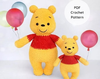 May include: Two crocheted Winnie the Pooh bears, one large and one small, holding balloons. The bears are yellow with red shirts and black eyes. The balloons are pink and blue. The image includes the text "PDF Crochet Pattern".