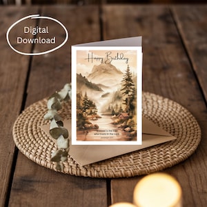 May include: A birthday card with a watercolor landscape scene featuring mountains, a river, and trees. The card reads "Happy Birthday" and includes the text "Blessed is the man who trusts in the Lord Jeremiah 17:7".