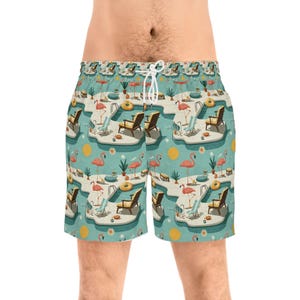 May include: Swim shorts featuring a repeating pool scene pattern. The design includes pink flamingos, sun loungers, and yellow suns on a light blue background. The shorts have a white drawstring.