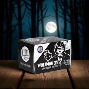 May include: A black and white box of Wolfman 35mm black and white film. The box features a graphic of a werewolf and the text "Wolfman 35" and "35MM Black and White Film". The background shows a full moon and a forest.