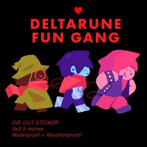 May include: A die-cut sticker featuring three cartoon characters from Deltarune, labeled "FUN GANG" in red text. The sticker is 3x2.5 inches and waterproof. The characters are in shades of green, purple, and pink, against a black background.