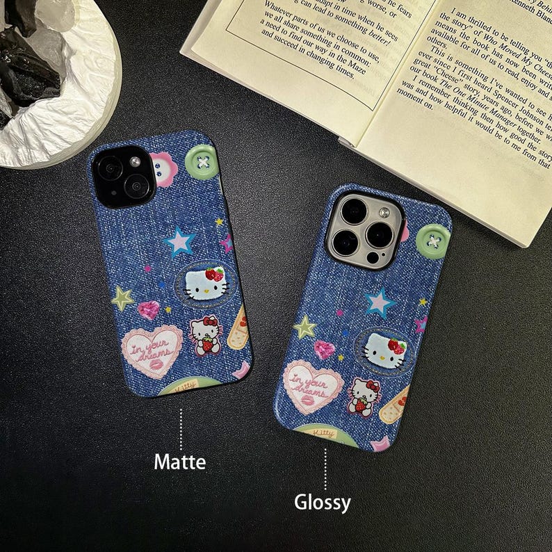 May include: Two phone cases with a denim design featuring Hello Kitty and stars. The case on the left is matte and the case on the right is glossy.