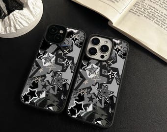 May include: Two black phone cases featuring a pattern of white stars and swirls. The cases are designed for an iPhone 14 Pro.