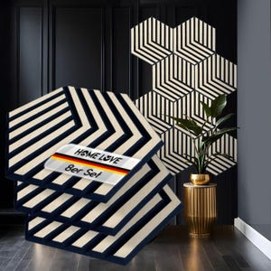 May include: Set of eight black and white striped hexagonal acoustic panels. The panels are made of wood and have a geometric design. The panels are arranged in a staggered pattern. The panels are labelled "Home Love 8er Set".