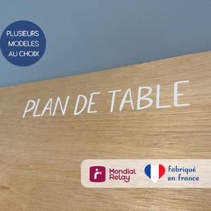 May include: A wooden sign with the text "PLAN DE TABLE" in white lettering. The sign is on a light blue wall. There are two logos at the bottom of the sign: Mondial Relay and a heart with the French flag. The text "Fabriqu&eacute; en France" is below the heart.