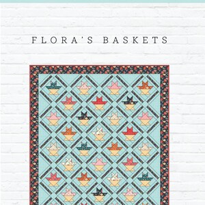 May include: A quilt pattern for a quilt called "Flora's Baskets". The quilt features a blue background with a repeating pattern of baskets and stars. The quilt is surrounded by a border of floral fabric. The pattern is by Gigi's Thimble Quilt Patterns.
