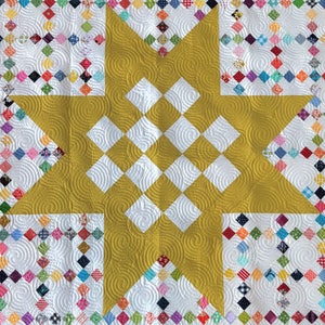 May include: A yellow star quilt block with a white background. The star is made up of smaller squares, and the background is filled with a variety of colorful squares.