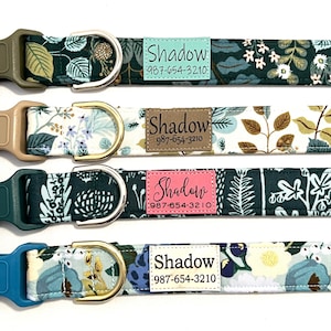 May include: Four dog collars with different colored buckles and floral patterns. Each collar has a tag with the name "Shadow" and a phone number. The collars are green, beige, dark green, and blue.