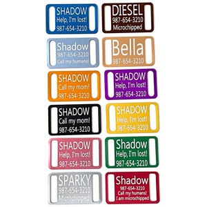 May include: A collection of 10 colorful metal dog tags with various text and phone numbers. The tags are all rectangular with rounded corners and have a hole at the top for attaching to a collar. The text on the tags includes names like Shadow, Diesel, Bella, and Sparky, as well as phone numbers and the phrase "Help, I'm lost!"