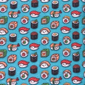 May include: A blue fabric with a repeating pattern of various sushi rolls. The sushi rolls are in different colors and shapes, including salmon, avocado, and cucumber.