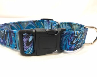 May include: A blue and purple marbled dog collar with a black plastic buckle and a silver D-ring.