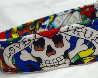 May include: A white fabric collar with a colorful tattoo-inspired design. The design features a skull, a banner with the word "LOVE", and a banner with the word "TRUE".