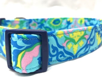 May include: A blue, pink, green, and yellow patterned dog collar with a navy blue buckle.