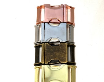 May include: Four metal slider buckles in different finishes: rose gold, silver, antique brass, and gold.