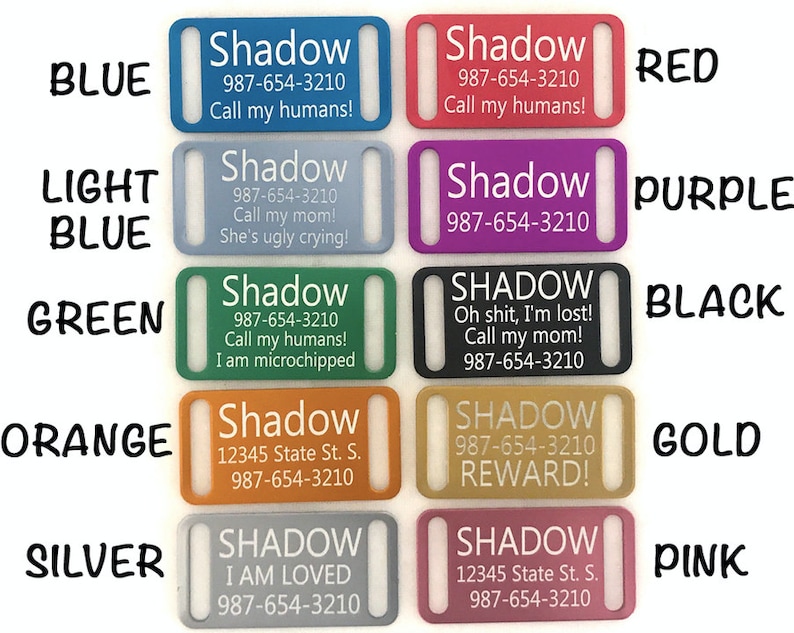 May include: Ten different colored dog tags with various text on them. The colors are blue, light blue, green, orange, silver, red, purple, black, gold, and pink. The text on the tags includes the name "Shadow", phone numbers, and various messages.