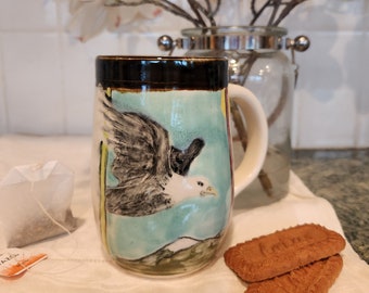 Mug featuring a bald eagle flying over the landscape