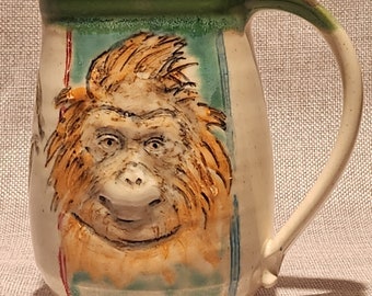 Beautiful orangutan portrait carved, sculpted, and hand-painted on a handmade ceramic mug