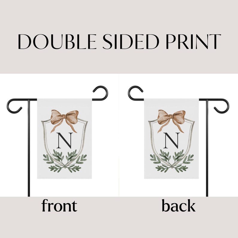 May include: Double-sided garden flag with a white background. The flag features a shield design with a bow, the letter "N", and greenery. The text "DOUBLE SIDED PRINT" is at the top. The front and back of the flag are shown.