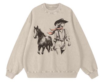 Sudadera extragrande estilo western con efecto nieve y estampado de vaquera y su caballo. Jersey de algodón.
