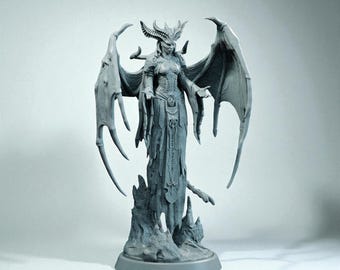 May include: A gray figurine of a winged demoness with a horned crown and flowing gown. The statue has large, detailed wings and is standing on a rocky base. The figure's pose suggests a commanding presence.