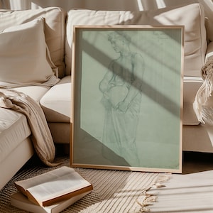 May include: A framed drawing of a person holding a pitcher, with a light green background and a wooden frame.