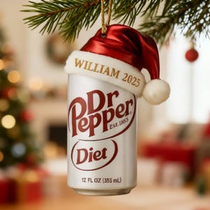 May include: A Dr Pepper Diet can Christmas ornament. The can is topped with a red Santa hat with the name "WILLIAM 2025" printed on it. The can reads "Dr Pepper Diet" and "12 FL OZ (355 mL)".