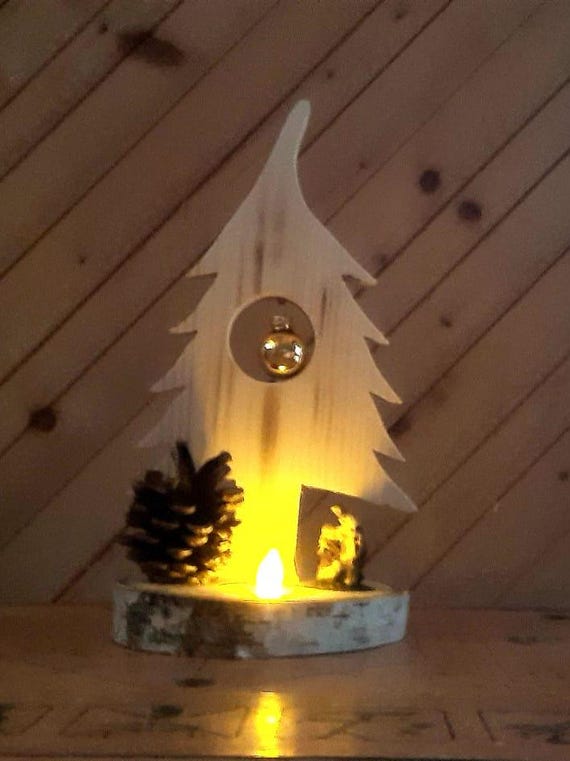 Christmas tree made of spruce on birch wood