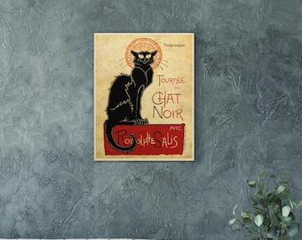 May include: A rectangular wall art print featuring a black cat with yellow eyes and a red halo sitting on a red platform. The text reads Tournée du Chat Noir avec Rodolphe Salis. The background is a textured cream color with vintage-style typography.